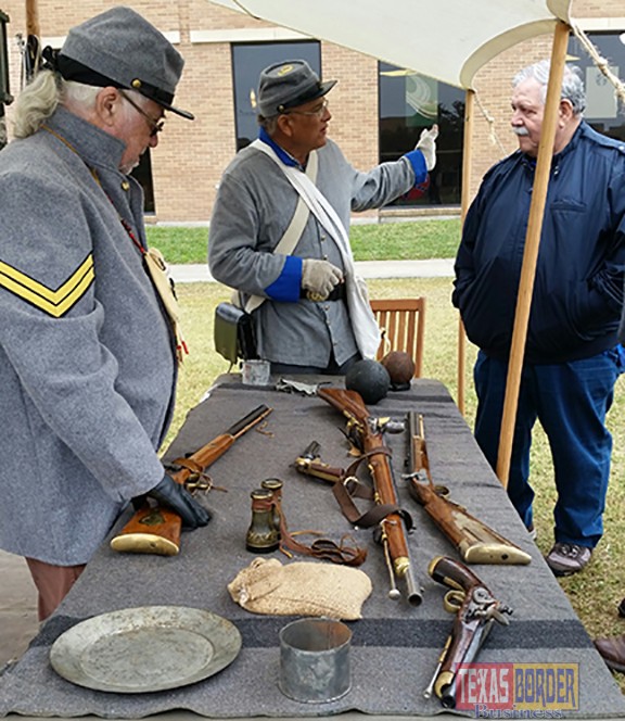 Civil War era military camp photo: Civil War re-enactors Rodger Wahl (left) and Ruben Martinez showed visitors replicas of Civil War-era weapons and other artifacts at their military camp re-enactment set up on UTPA's Student Union Quad as part of the Rio Grande Valley Civil War Trail launch on Feb. 28.