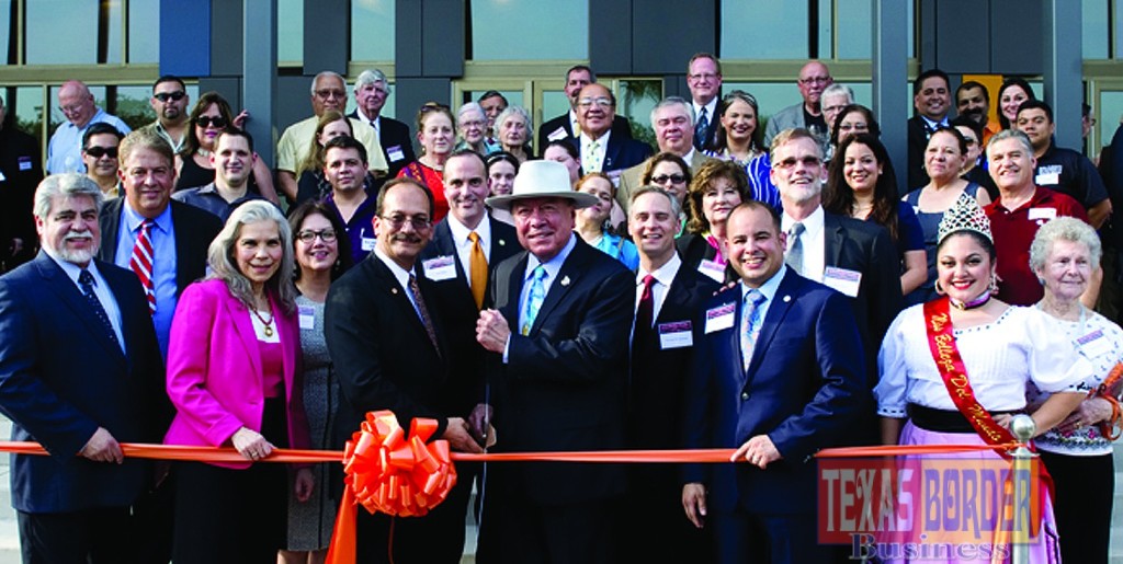 Dr. Havidán Rodríguez (left), UTPA president ad interim and provost and executive vice president for Academic Affairs at UTRGV, and State Senator Juan "Chuy" Hinojosa hold the scissors as they cut the ribbon at the grand opening April 23 of the Performing Arts Complex at the Edinburg campus.
