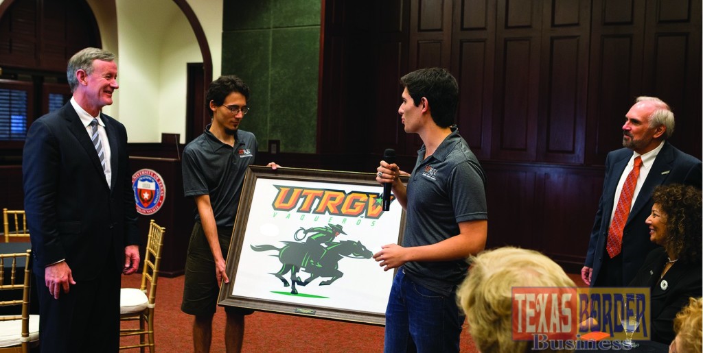 UT System Chancellor William McRaven received a framed copy of the UTRGV mascot from UTRGV Student Government Association President Alberto Adame (holding the microphone) on the first day of class, Monday, Aug. 31, 2015, at Salon Cassia in Brownsville. Looking on is UTRGV President Guy Bailey (far right). (UTRGV Photo by Paul Chouy)