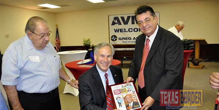 Greg Abbott receives from Texas Border Business Publisher Roberto Hugo Gonzalez a plaque. Abbot was featured in Texas Border Business front cover. Mayor Polo Palacios witnessing the event. Photo archive
