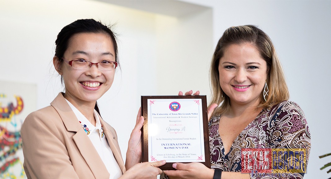 UTRGV student Yuanqing Li, named 2016 Outstanding International Female Student, here accepts her plaque from International Admissions and Student Services Director Samantha Lopez on Tuesday, March 8, at the UTRGV Performing Arts Complex in Edinburg, during the International Women’s Day Celebration. (UTRGV photo by Paul Chouy)