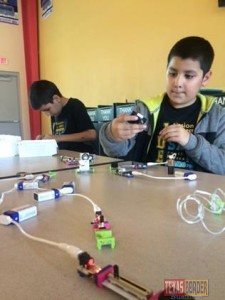Club members Gabriel and Joshua De la Garza exploring circuit designs using electronic building blocks.