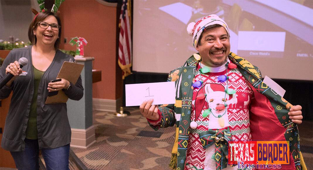 The UTRGV School of Medicine held its annual Ugly Sweater Contest, pitting faculty and staff from the Harlingen and Edinburg campuses against each other for the right to brag about having the ugliest holiday sweater, hands down. The SOM also collected gifts for families they are sponsoring in the Indian Hills neighborhood near Mercedes. Here, sweater contest champion Vicente Reyna proudly struts his stuff as the overall contest winner, to the amusement of Nina Jimenez, from the Graduate Medical Education department. (UTRGV Photo by David Pike)