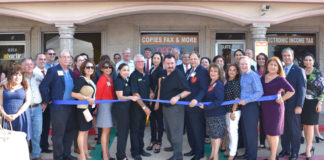 McAllen Chamber of Commerce cuts the ribbon at Advertir’s 40th anniversary reception. In the center in black polos are the staff, from left Vanessa Robledo, office manager, Christopher Julian, President, Gladys Rodriguez, sales assistant & Ralph De Anda, V.P