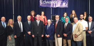 Edwards Abstract and Title Co. welcomed Dr. Ted C. Jones, Ph.D. as the guest speaker during the 14th Annual State of Real Estate Forum held on March 8, 2018. For the past fourteen years the State of Real Estate Forum is coordinated and presented by Edwards Abstract and Title Co. as a resource for real estate industry professionals. Pictured are members of the Edwards Management Team and special invited guests. (First row L-R) Brandon Linscomb, Stewart Title Guaranty Co.; Elva Jackson Garza, Edwards Abstract and Title Co.; Mark S. Pena, Lewis, Monroe & Pena, LLC; Alan Monroe, Lewis, Monroe & Pena, LLC; Dr. Ted C. Jones, Sr. Vice President & Chief Economist with Stewart Title Guaranty Co.; Mayor Jim Darling, city of McAllen; Byron Jay Lewis, Edwards Abstract and Title Co.; N. Michael Overly, Edwards Abstract and Title Co.; D.D. Hoffman, Edwards Abstract and Title Co.; Chris Hughston, Edwards Abstract and Title Co.; and William Rountree, Law Office of William Rountree. Back row: Pamela Dougherty, Edwards Abstract and Title Co.; Mariana R. Ramirez, Edwards Abstract and Title Co.; Marilyn De Luna, Edwards Abstract and Title Co.; Letty Rodriguez, Edwards Abstract and Title Co.; and Diana S. Kaufold, Edwards Abstract and Title Co.