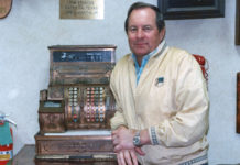 Joe LaMantia, Jr. next to an antique cash register. If was his preference for this picture to be taken next to the cash register. Photo taken on July 1988 and published in Texas Border Digest August 1988. Photo by Roberto Hugo González.