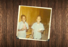 Picture of Two young African American boys receive Christmas gifts from the Boys Clubs of Edinburg, Inc in 1971.