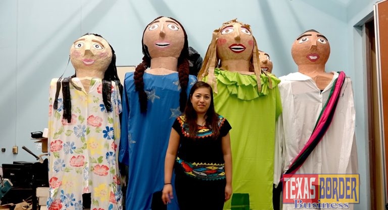 Lucero Rodriguez, president of the UTRGV Latino Theatre Initiatives, stands on a chair to pose with the UTRGV mojigangas, enormous puppets the student organization made this spring. The group is including the 11-foot-tall puppets in a play they’ll be performing in October in Brownsville and Edinburg. In the play, a girl’s homemade dolls come to life. (UTRGV Photo by Maria Elena Hernandez)