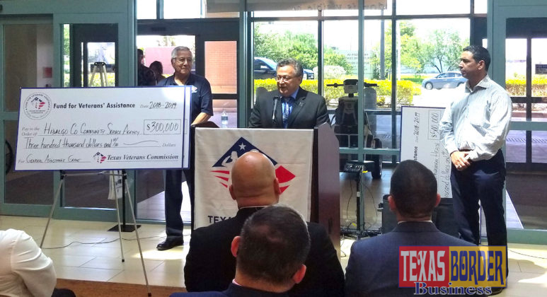 Community Service Agency Director Jaime Longoria (at podium) and Precinct 1 Commissioner David L. Fuentes (right) accept the check from the Texas Veterans Commission.