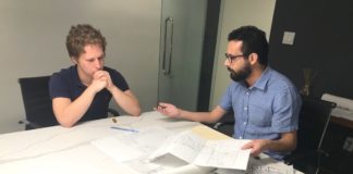 Braxton Hornbuckle consulting with an associate of Chanin Engineering, Alan Castillo.