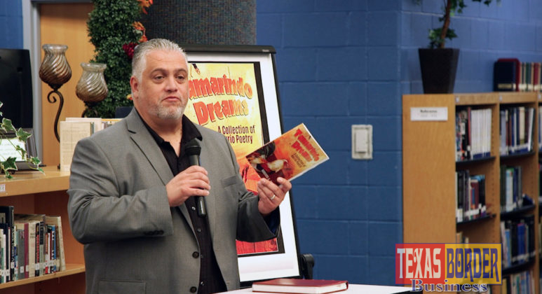 Author Roberto Rocha holds his book “Tamarindo Dreams: A Collection of Barrio Poetry,” while visiting with students at Edinburg High School.
