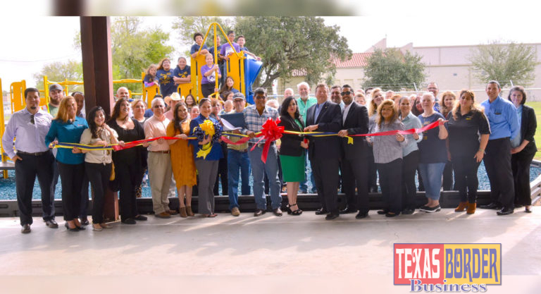 Lasara, Texas community with members of Magic Valle Electric Coop. and Noble Texas Builders celebrating the ribbon cutting ceremony of the playground expansion that includes playground and water fountain equipment for all Lasara children. Photo by Roberto Hugo Gonzalez