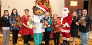 DHR Health receives a donation of teddy bears from Paula Owen and Irene Quail, representing the Rio Grande Chapter National Society Daughters of the American Revolution. Pictured from left to right: Norma Teran, DNP, MBA, RN, Chief Nursing Officer, DHR Health; Elizabeth Adamson, DNP-HI, MSN, RN, BC, Chief Nursing Information Officer, DHR Health; Lesley Anne Durant, JD, CHC, CHPC, Chief Compliance and Privacy Officer, DHR Health; Dr. Ted E. Bear; Paula Owen; Irene Quail; Lisa R. Treviño, PhD, Vice President for Research and Development; Mario Garza. Jr., MSN, RN, Vice President of Surgery and Procedural Services, DHR Health.
