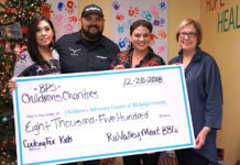 Yadi Robles, Fred Robles presenting check to Children's Advocacy Center Development Directors Tracy Gerdes and Pat Blum.