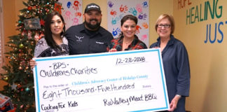 Yadi Robles, Fred Robles presenting check to Children's Advocacy Center Development Directors Tracy Gerdes and Pat Blum.