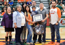 Amanda Cruz, an interdisciplinary studies sophomore at UTRGV, won the 2019 Family of the Year essay. Shown here surrounded by her son, husband and other family members who are helping her achieve her dreams of graduating university, she was recognized at the UTRGV Homecoming Basketball game in February. She was also recognized again by throwing the first pitch at UTRGV Baseball’s Selena Night on April 6 in Edinburg. (Courtesy Photo)