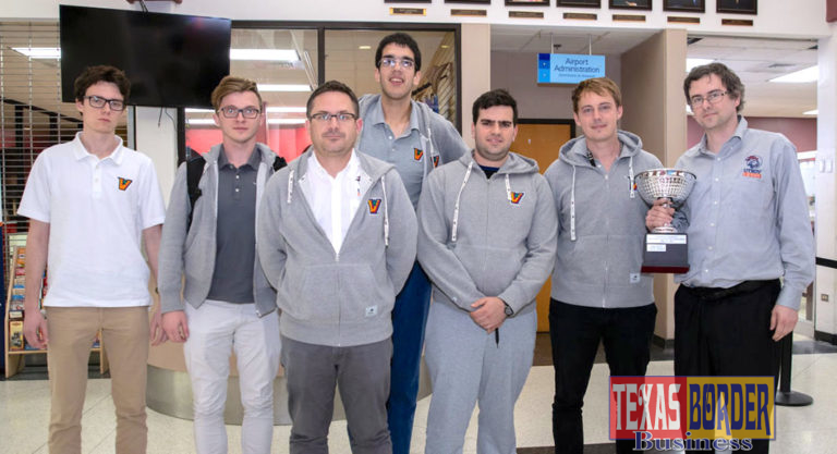 The UTRGV Vaqueros Chess Team returned to the Rio Grande Valley just after 12 a.m. Monday from New York City, riding its second consecutive national win over rival Webster University in the Final Four of Collegiate Chess. The team is seen here just after arrival at the Brownsville South Padre Island International Airport. Coach Bartek Macieja, far right, proudly displays the President’s Cup trophy. (UTRGV Photo by David Pike)