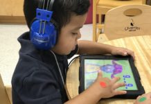An Edinburg CISD prekindergarten student uses a tablet to complete his spelling and reading assignments.