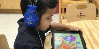 An Edinburg CISD prekindergarten student uses a tablet to complete his spelling and reading assignments.