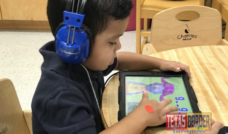 An Edinburg CISD prekindergarten student uses a tablet to complete his spelling and reading assignments.