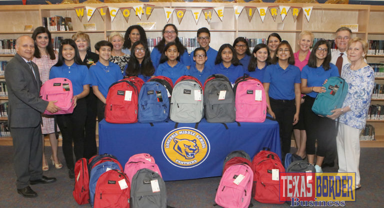 Longoria Middle School National Junior Honor Society members, Edinburg CISD administrators and Edinburg Rotarians are pictured with backpacks filled with school supplies that will be distributed to students at the campus.