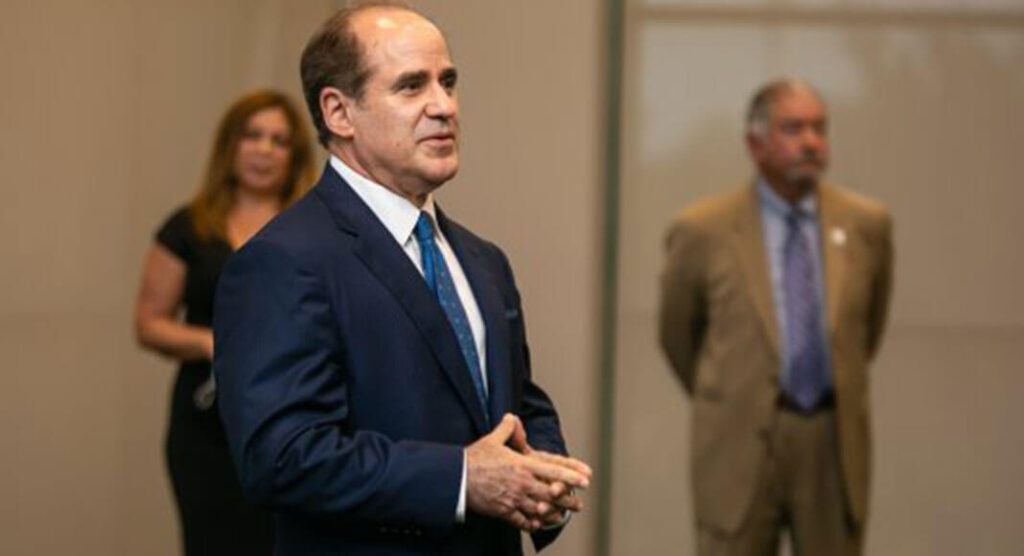 South Texas College President Dr. Ricardo J. Solis shares his vision for the college as Board Chair Rose Benavidez and Trustee Paul R. Rodriguez (background) look on. At a special reception at STC's Pecan campus July 29, Dr. Solis gathered with trustees and the search committee which assisted in his placement as the college's next president. STC Image