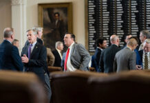 Legislators talk on the House floor on July 29, 2021. Credit: Sophie Park/The Texas Tribune