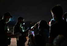 U.S. Customs and Border Protection officers apprehend asylum-seekers who recently crossed the border in Roma on Aug. 3, 2021. Photo Credit: Sophie Park/The Texas Tribune