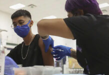 Angel Castro, 16, received his first shot of the Pfizer vaccine at William D. Slider Middle School in El Paso on July 22, 2021. After being battered by COVID-19 surges last year, El Paso has been a bright spot during the delta surge.  Photo Credit:  Briana Sanchez/El Paso Times via REUTERS