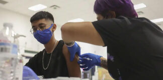 Angel Castro, 16, received his first shot of the Pfizer vaccine at William D. Slider Middle School in El Paso on July 22, 2021. After being battered by COVID-19 surges last year, El Paso has been a bright spot during the delta surge.  Photo Credit:  Briana Sanchez/El Paso Times via REUTERS