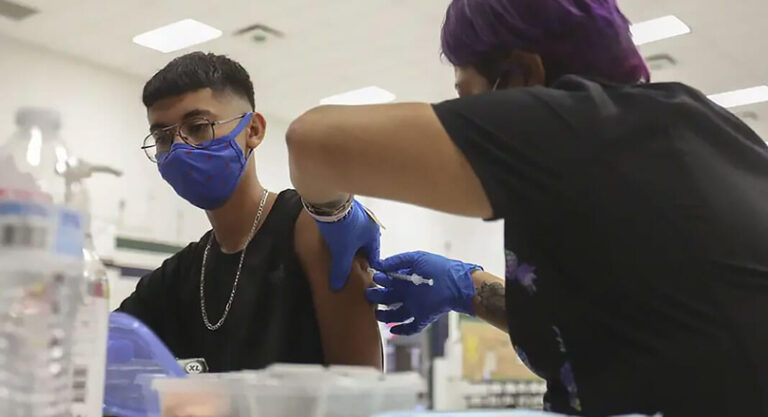 Angel Castro, 16, received his first shot of the Pfizer vaccine at William D. Slider Middle School in El Paso on July 22, 2021. After being battered by COVID-19 surges last year, El Paso has been a bright spot during the delta surge.  Photo Credit:  Briana Sanchez/El Paso Times via REUTERS