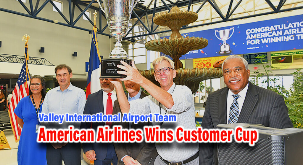 A triumphant moment at Valley International Airport in Harlingen, Texas, as Robbert Van Doin holds the cup, symbolizing American Airlines' top-ranking victory in their internal competition for Q2 of 2023. Joined by colleagues Raquel Alaniz Carmichael, Marv Esterly, John James, Kevin Ward, and George McShan, Board Chair. Van Doin revels in an achievement that reflects dedication to safety, quality, and customer satisfaction. The celebration captures the essence of a team setting high standards within the industry.