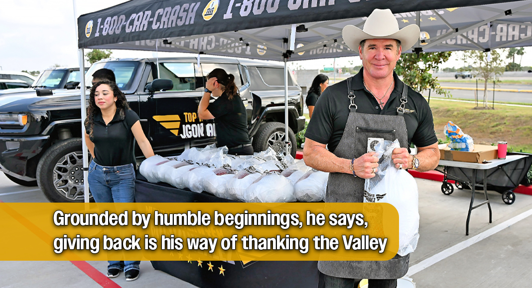 Attorney J. Gonzalez, supported by his staff, holds a turkey ready for distribution at the firm’s Thanksgiving giveaway outside their Edinburg headquarters. Photo by Roberto Hugo González / Texas Border Business