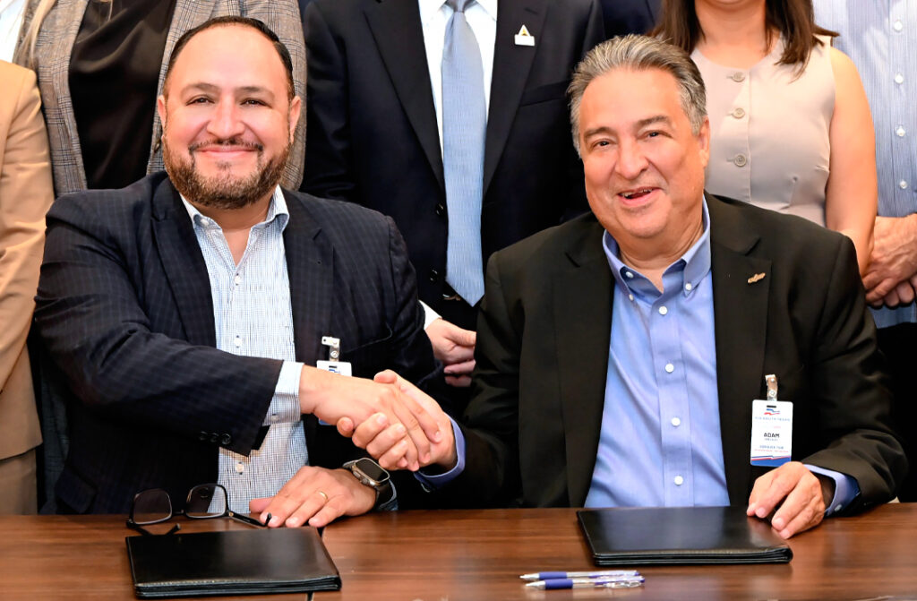 Luis Alberto González Olvera, director general of the San Luis Potosí Automotive Cluster, and Adam Gonzalez, chief executive officer of the Council for South Texas Economic Progress (COSTEP), shake hands after signing a memorandum of understanding at the conclusion of a meeting in McAllen. The agreement formalizes a commitment to strengthen collaboration and expand economic development, trade and investment opportunities between the San Luis Potosí automotive industry and the Rio South Texas region. Photo by Roberto Hugo González / Texas Border Business.