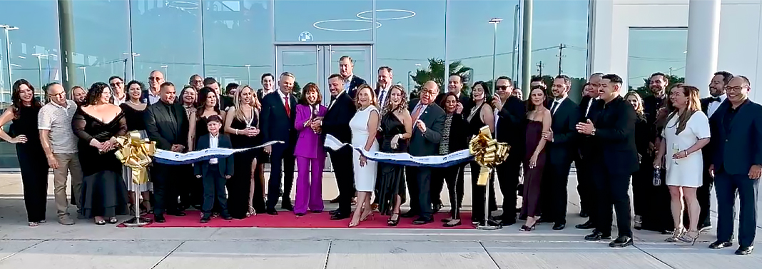 Janet Ogden Vackar and BMW of Pharr General Manager Patrick Fralick cut the ribbon during the dealership’s official grand opening, surrounded by friends and members of the Bert Ogden Auto Group team. Photo by Noah Mangum González / Texas Border Business.