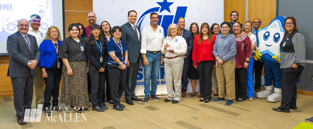 The City of McAllen leadership team and staff gather for a group photo alongside their star mascot during a community presentation and recognition event. Image courtesy of The City of McAllen