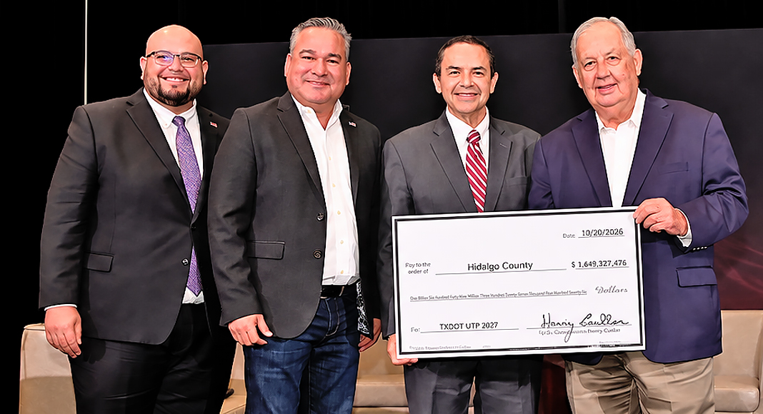 From left to right: Paco Sanchez, President and CEO of the Rio Grande Valley Partnership; Hidalgo County Commissioner Ever Villarreal; U.S. Congressman Henry Cuellar; and Hidalgo County Judge Richard Cortez during the presentation of a ceremonial check representing $1,649,327,476 in secured federal transportation funding at the Rio Grande Valley Partnership Infrastructure Summit on October 20, 2026, in Mission, Texas. Photo by Texas Border Business.