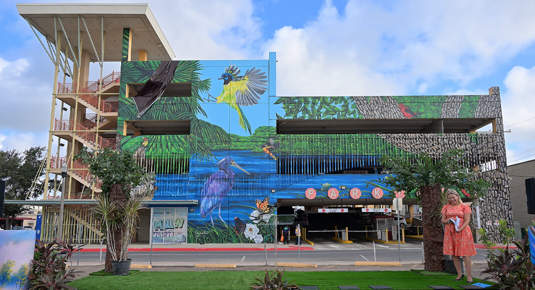 The completed Soaring Through McAllen mural by artist Oneida Aceves Treviño celebrates the Rio Grande Valley’s natural beauty and wildlife. Spanning more than 14,000 square feet, the artwork is located at a downtown McAllen parking garage. Residents and visitors are invited to see the mural in person and photograph this impressive addition to the city’s public art collection. Photo by Texas Border Business.